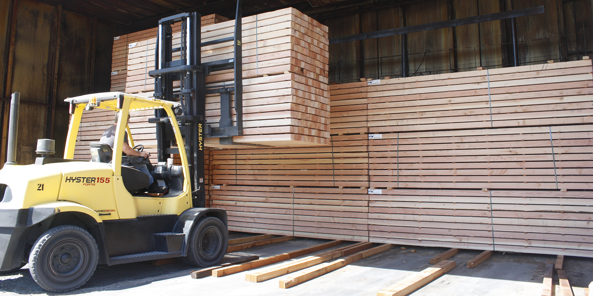 Forklift lifting wood in Clackamas Business