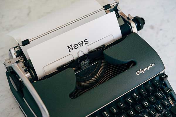 Typewriter with page that says news