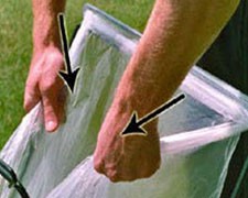 Man tugging edges of bag