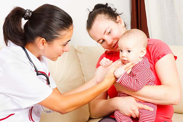 A nurse checking a baby