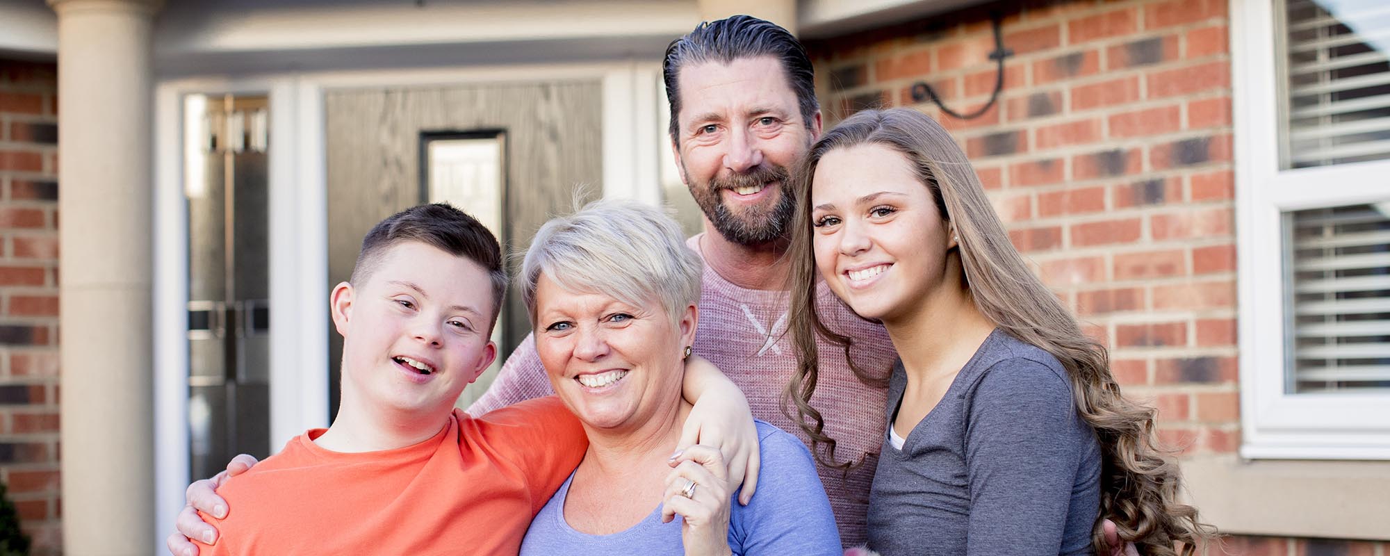 family in front of house