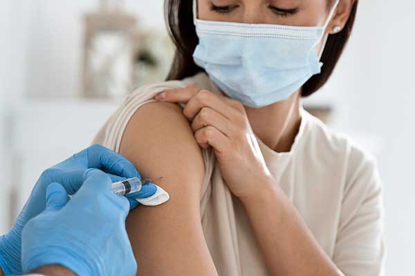 Young woman receiving injection