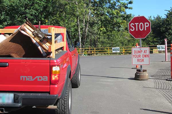 Truck with debris pulling into transfer station