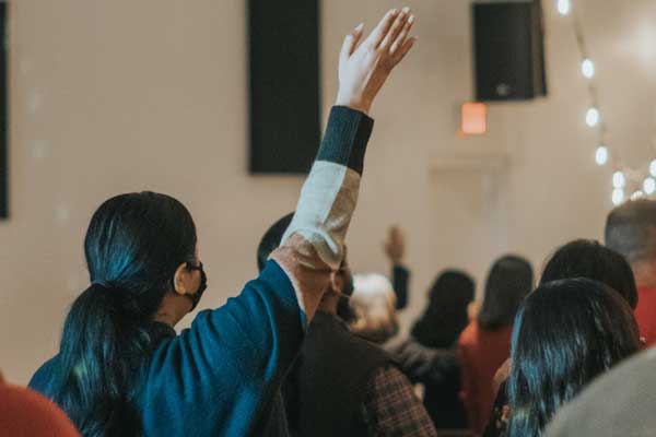 Woman raising her hand to ask question