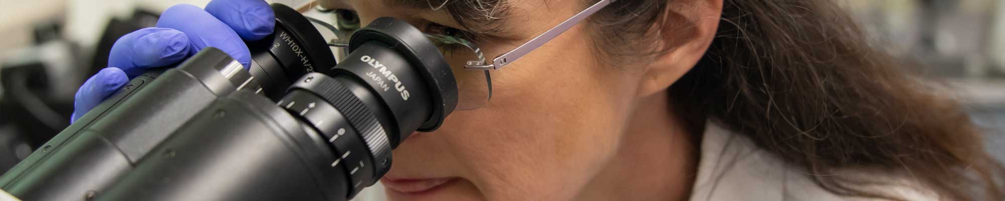 Looking through a microscope at the WES lab