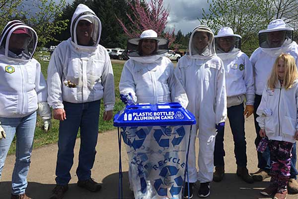 Volunteers collecting recyclables at an outdoor event
