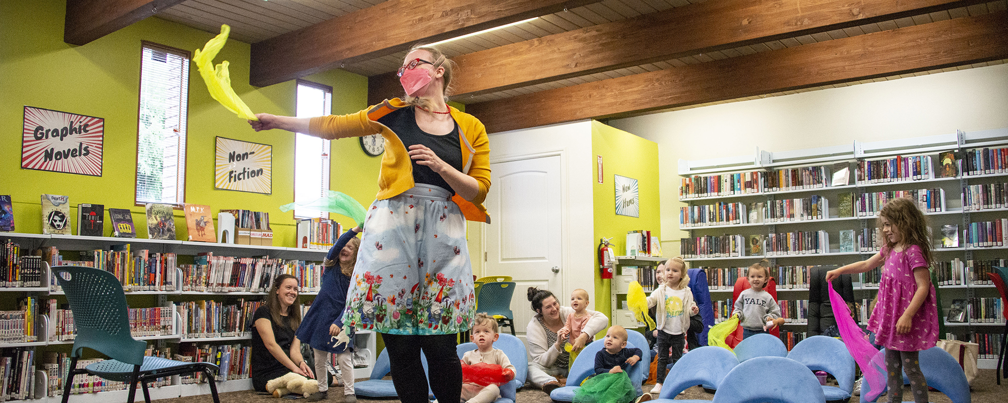 Woman shows kids how to throw scarves and danced at storytime at the gladstone library