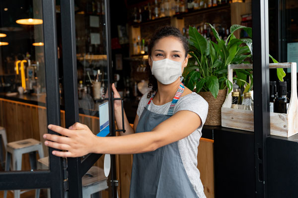 Woman wearing a face mask at her business