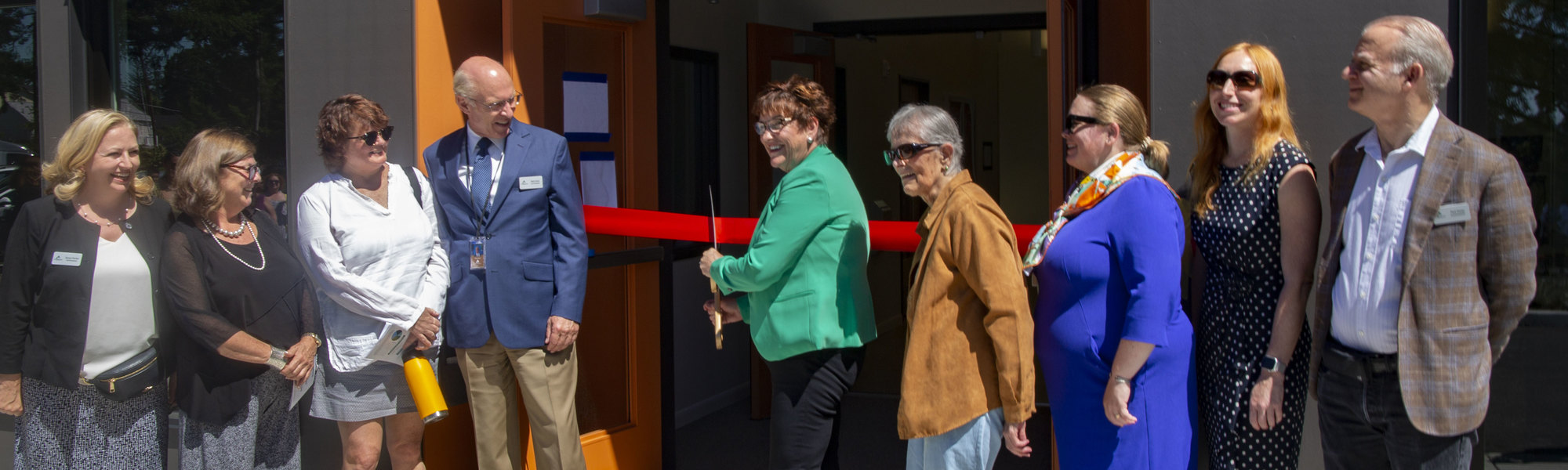 Commissioners and others cut the ribbon at the Tukwila Springs grand opening