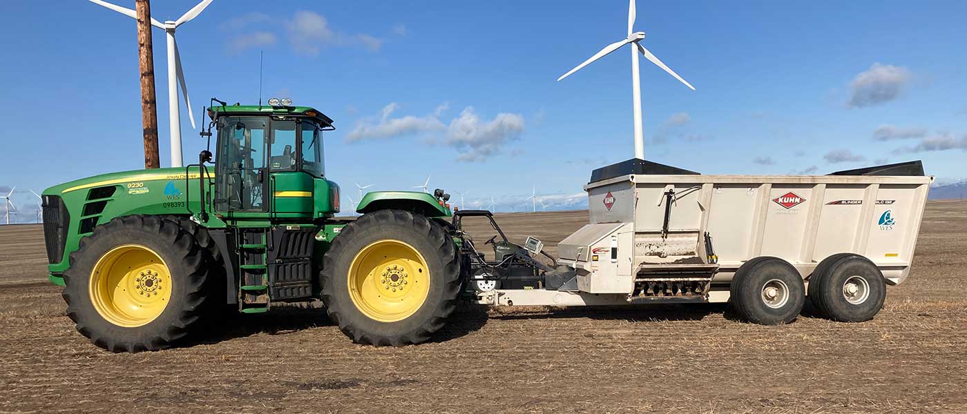 Tractor and spreader in field