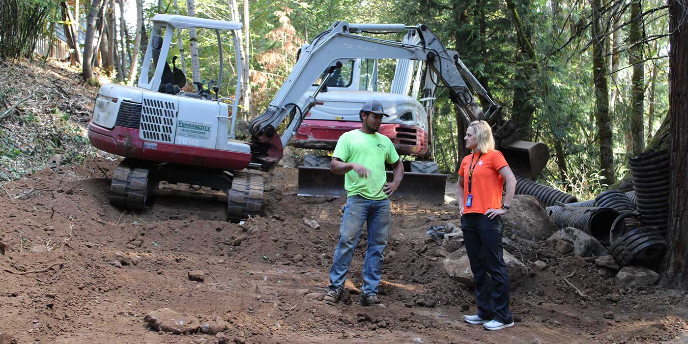 man and women working on stormwater repairs