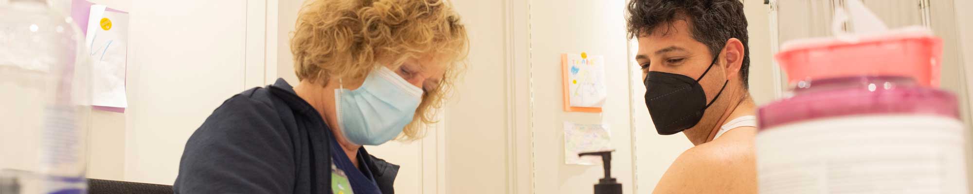 Man receiving a vaccination at a local clinic