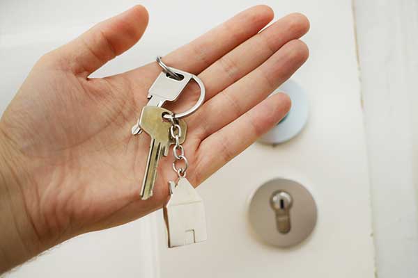 Hand holding apartment keys