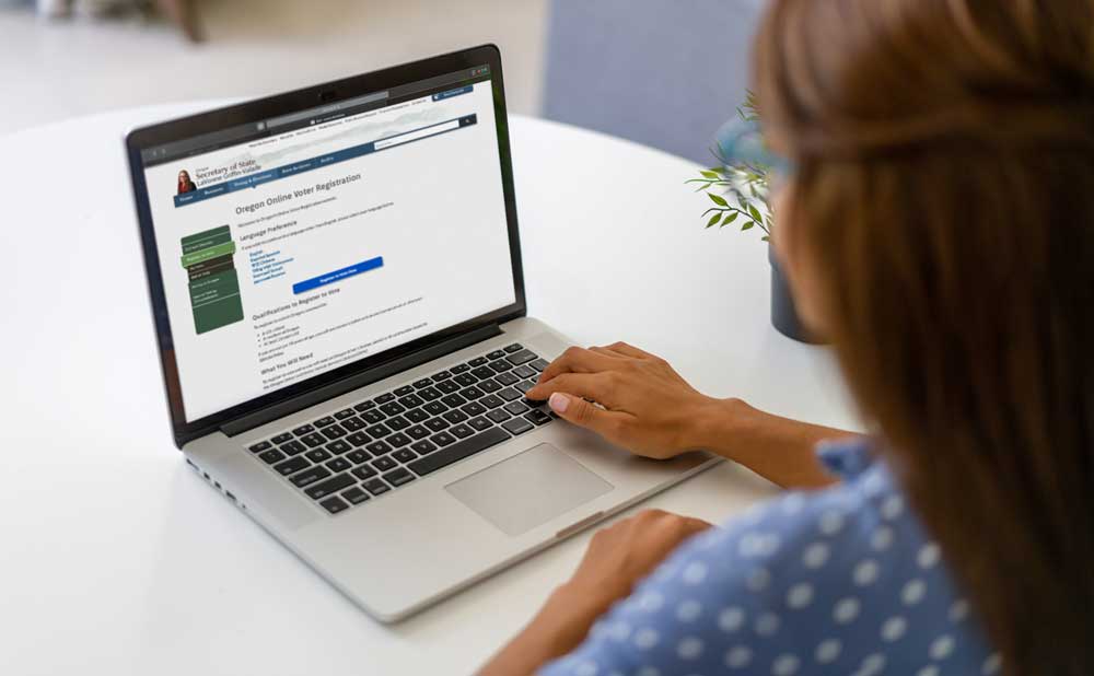 Woman registering to vote on a laptop