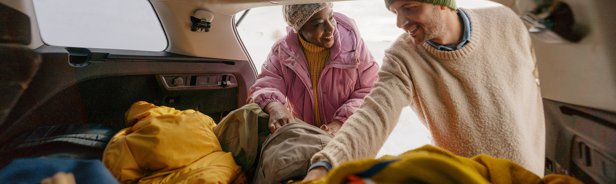 Couple packing their car for winter safety supplies