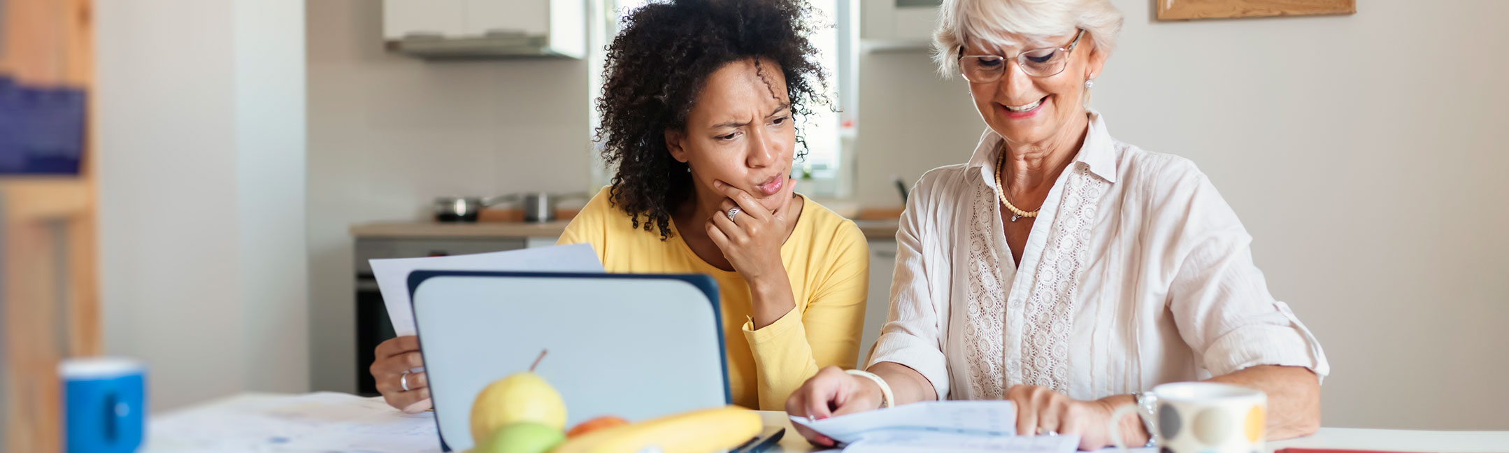 Young woman helping a senior woman apply for Medicare