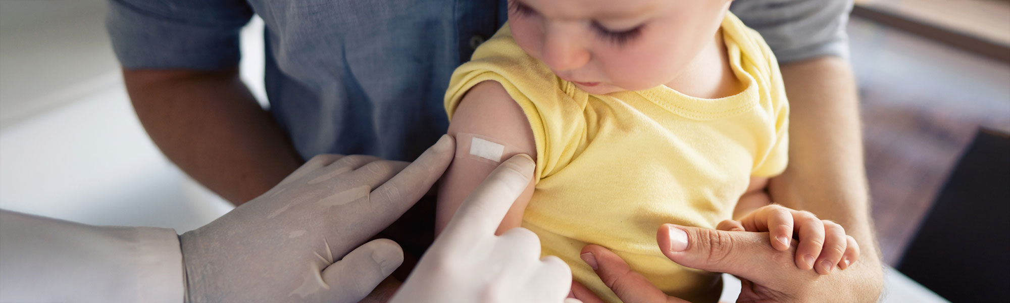 Doctor putting bandage on a child