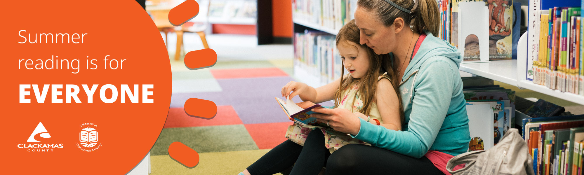 Mother and daughter reading in the library