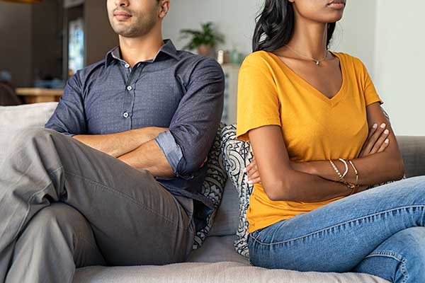 man and women sitting next to each other looking away