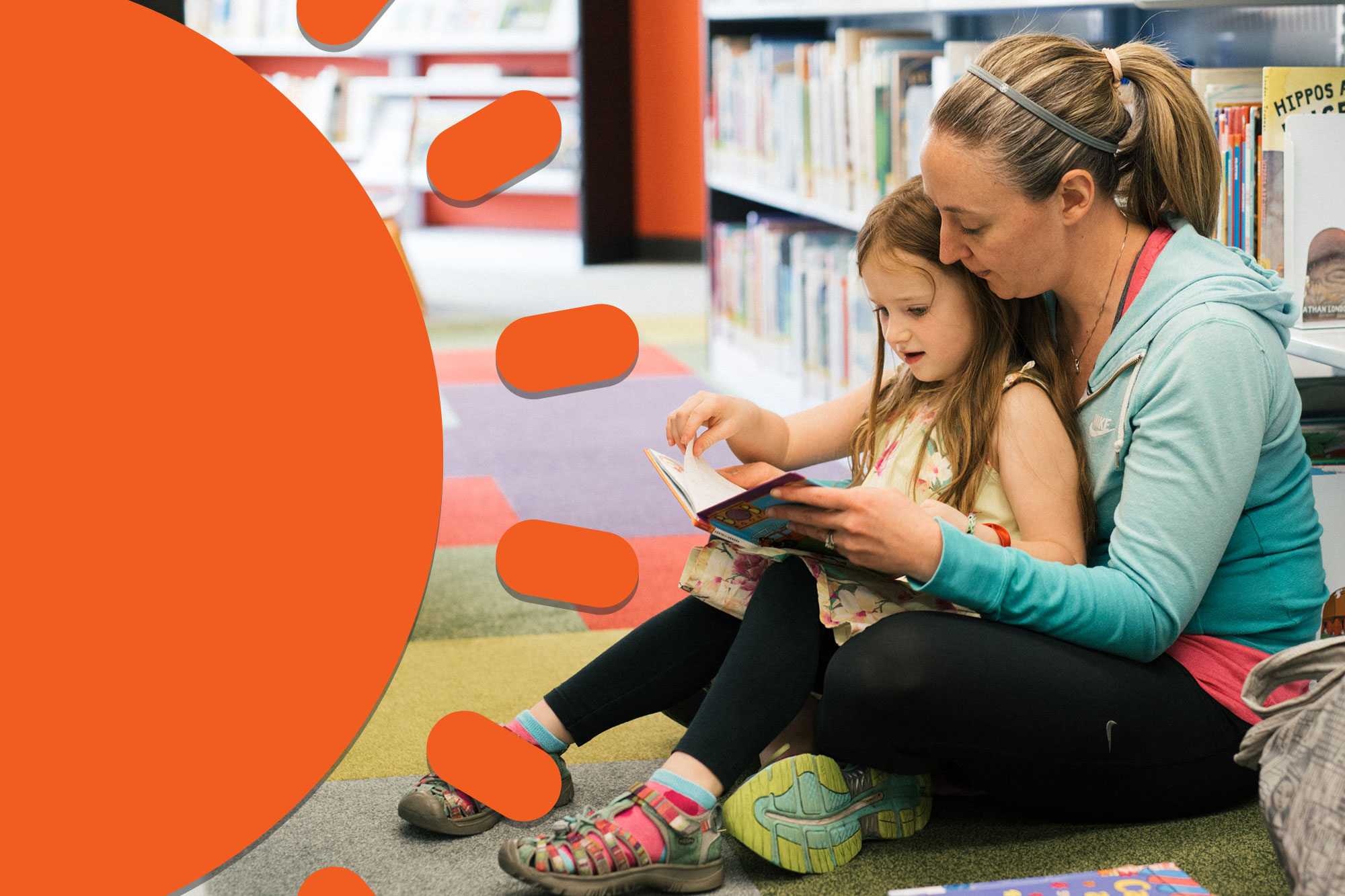 Mother and daughter reading in a library