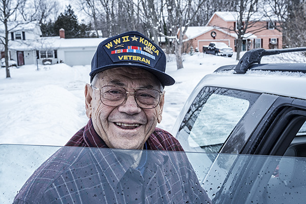 Elderly Vietnam veteran getting into a car