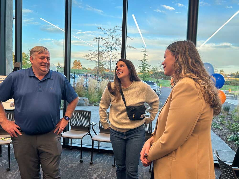 people looking at a sign, learning about the Sunrise Corridor project