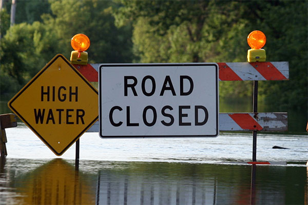 Flooded road with Road Closed and High Water signs