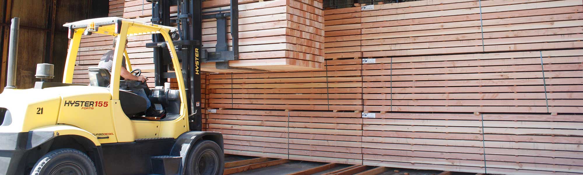 Forklift lifting wood in Clackamas Business
