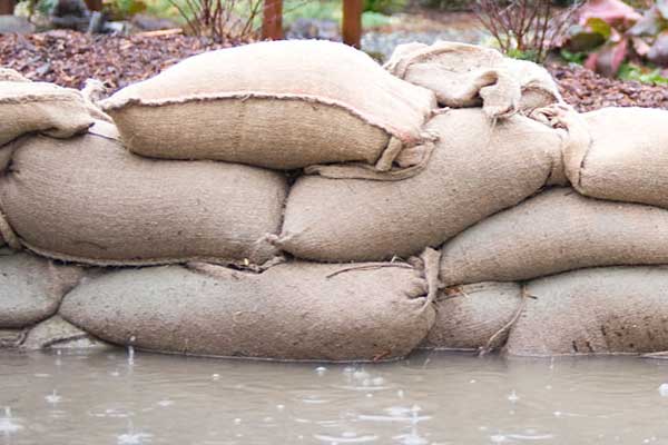Sandbags piled up near flood water