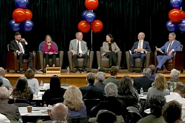 Commissioners seated on a stage discussing the direction of the county
