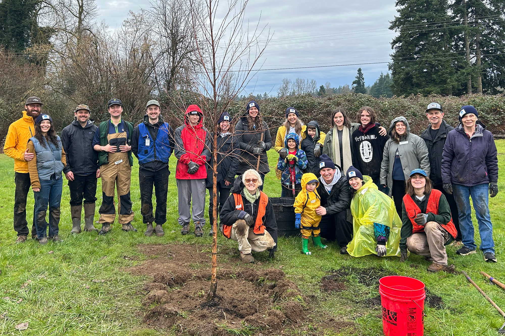 Friends of Trees in front of a sapling