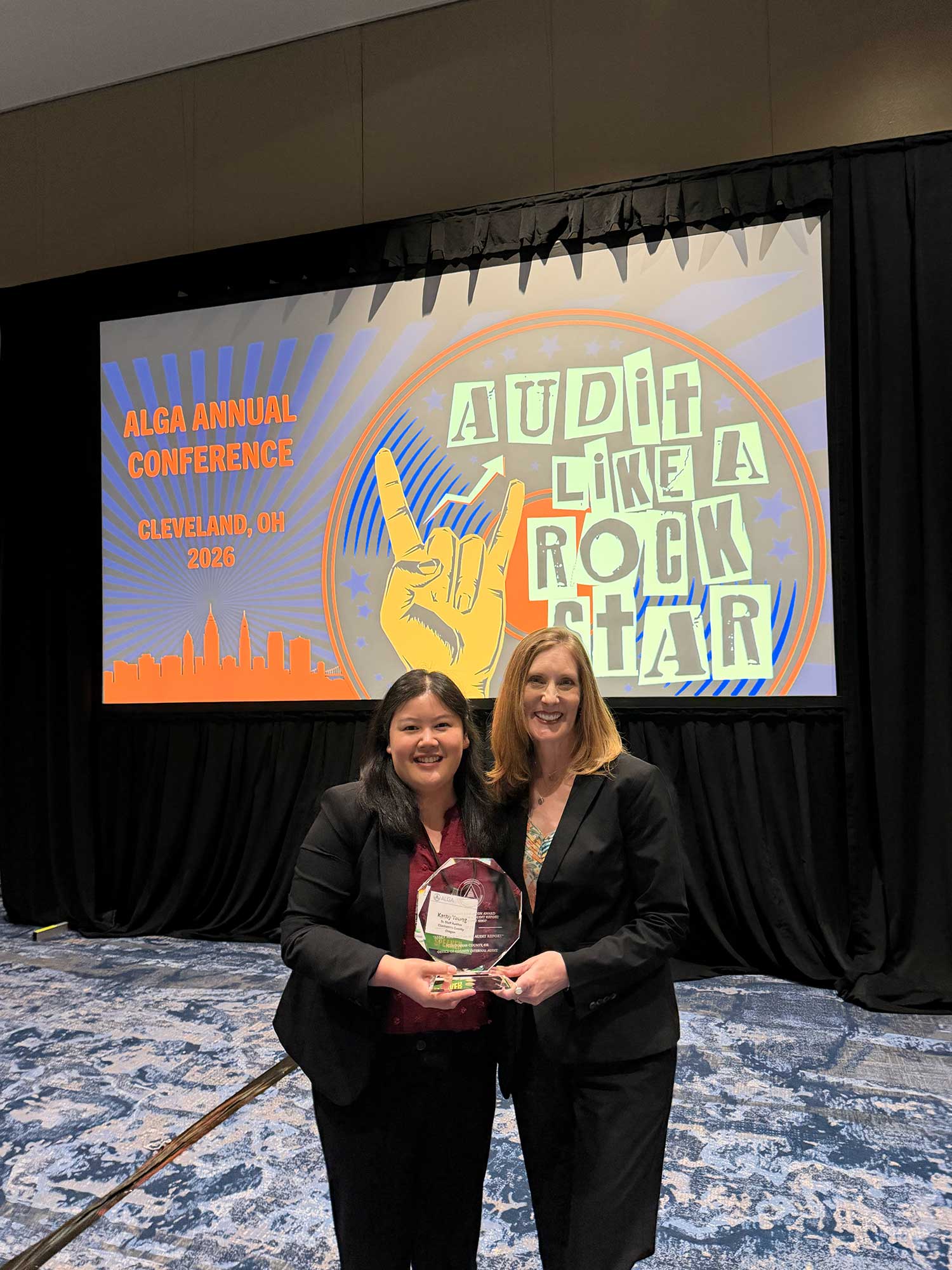 County Internal Auditor Jodi Cochran and Senior Internal Auditor Kathy Yeung holding the award