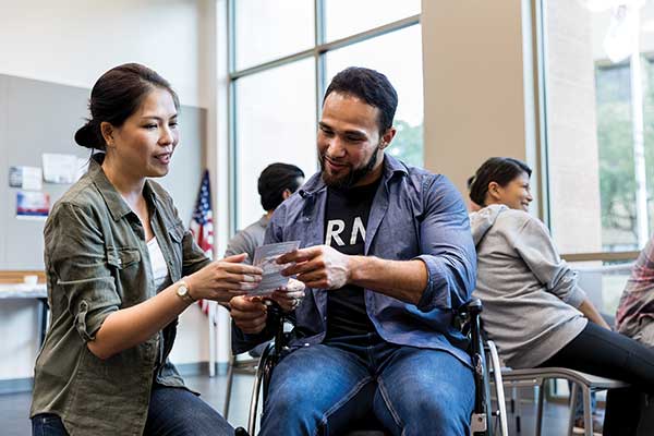 women helping a veteran review benefits