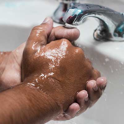 Close-up of man washing hands