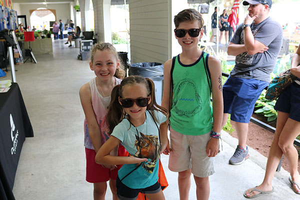 Three kids having fun at the County Fair