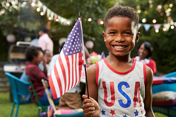 Little boy holding an American flag