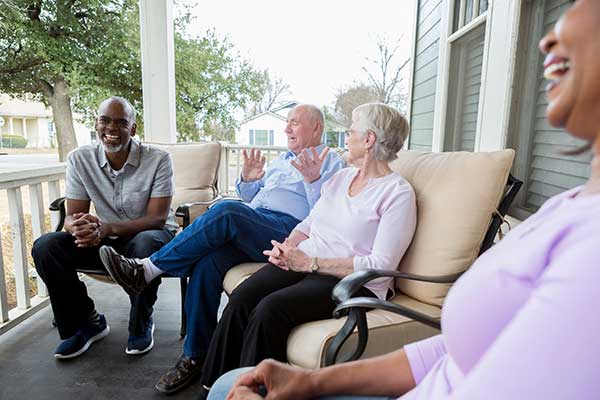 Community members talking on the porch