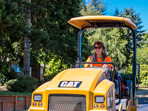 Woman driving a pavement roller