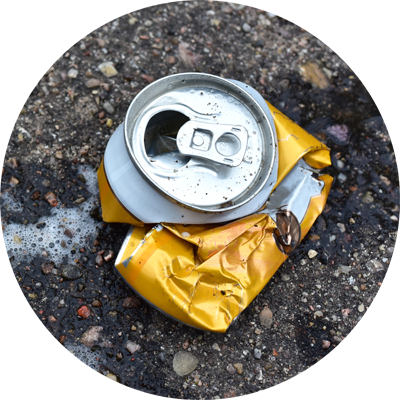 Squashed aluminum can littered on the ground