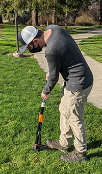 Man weed wacking his yard