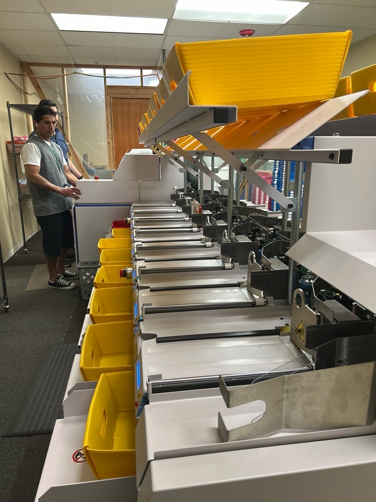 Elections Staff operate the new mail ballot sorter