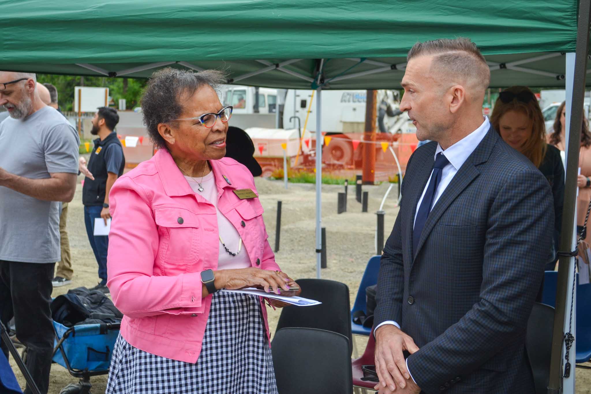 Oregon City Mayor Denyse McGriff talking to man at groundbreaking 