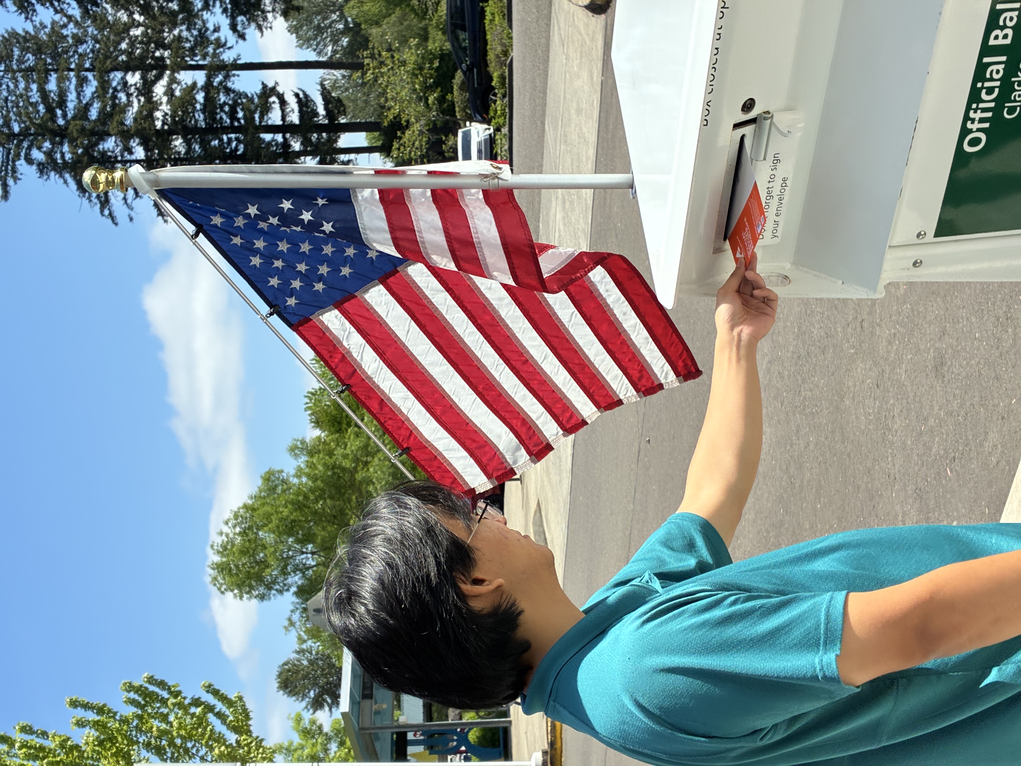 Voter returns ballot to an official ballot drop site outside the Happy Valley Library