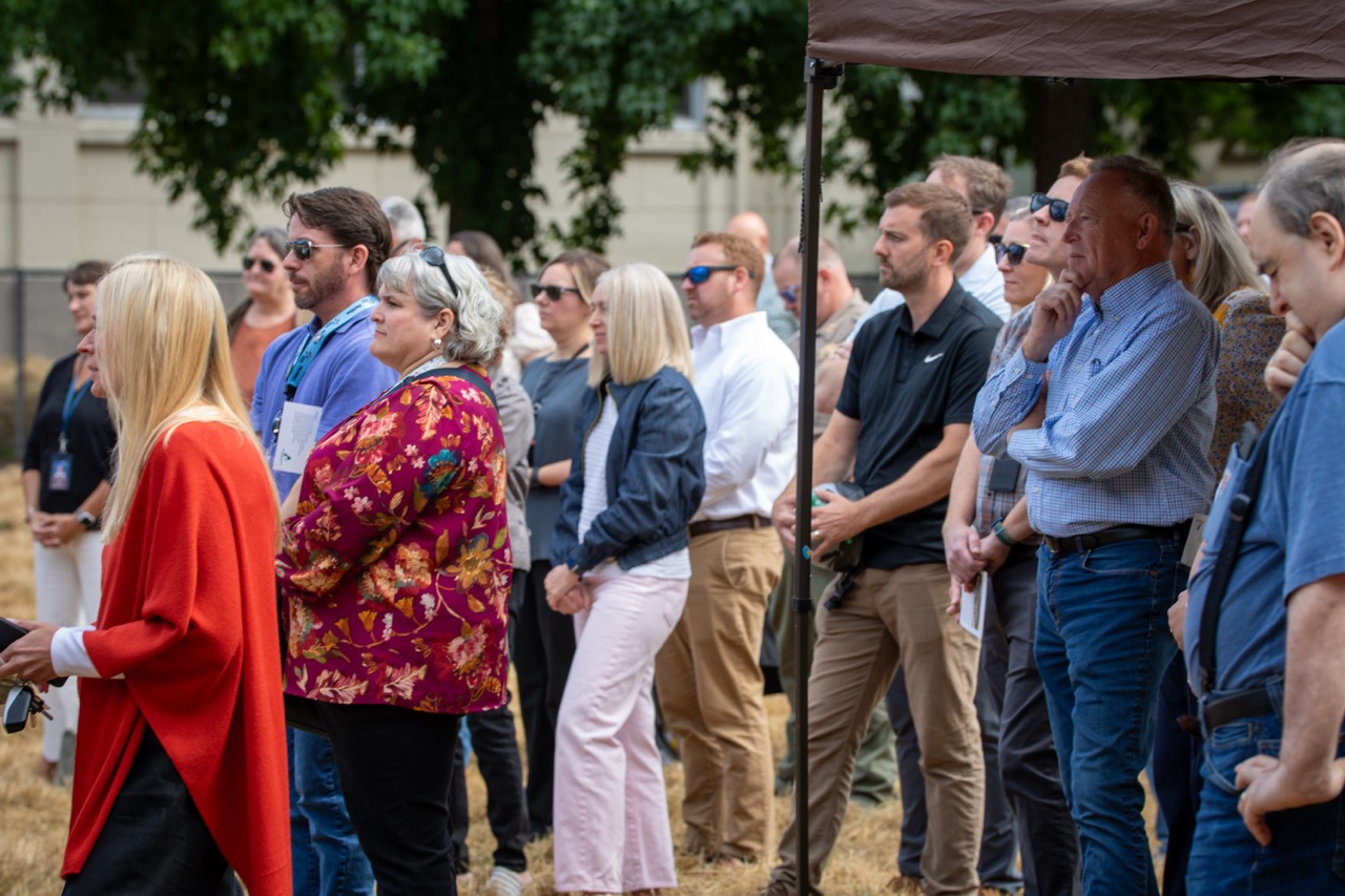 A crowd of people watches the speakers at the Clackamas County Recovery Campus groundbreaking on July 29, 2026.