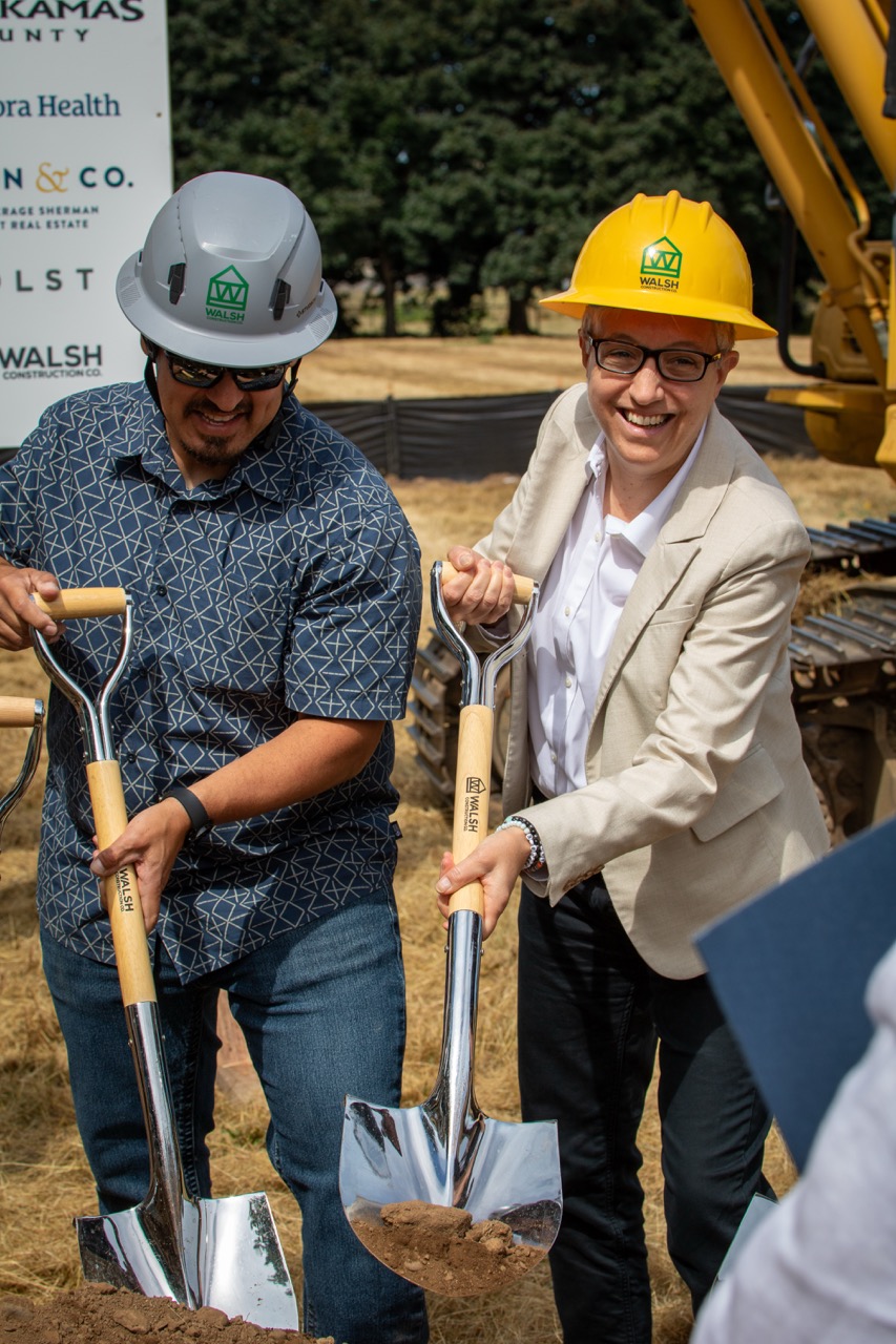 Gov. Tin Kotek is smiling holding a shovel with another person at the Clackamas County Recovery Campus groundbreaking on July 29, 2026.