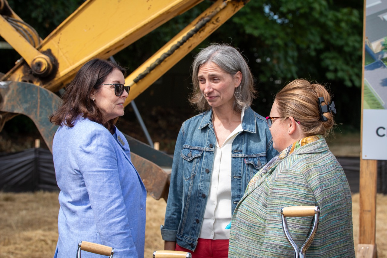 Clackamas County Commissioner Diana Helm chats with Oregon Rep. Maxine Dexter and Metro Councilor Christine Lewis at the Clackamas County Recovery Campus groundbreaking on July 29, 2026.