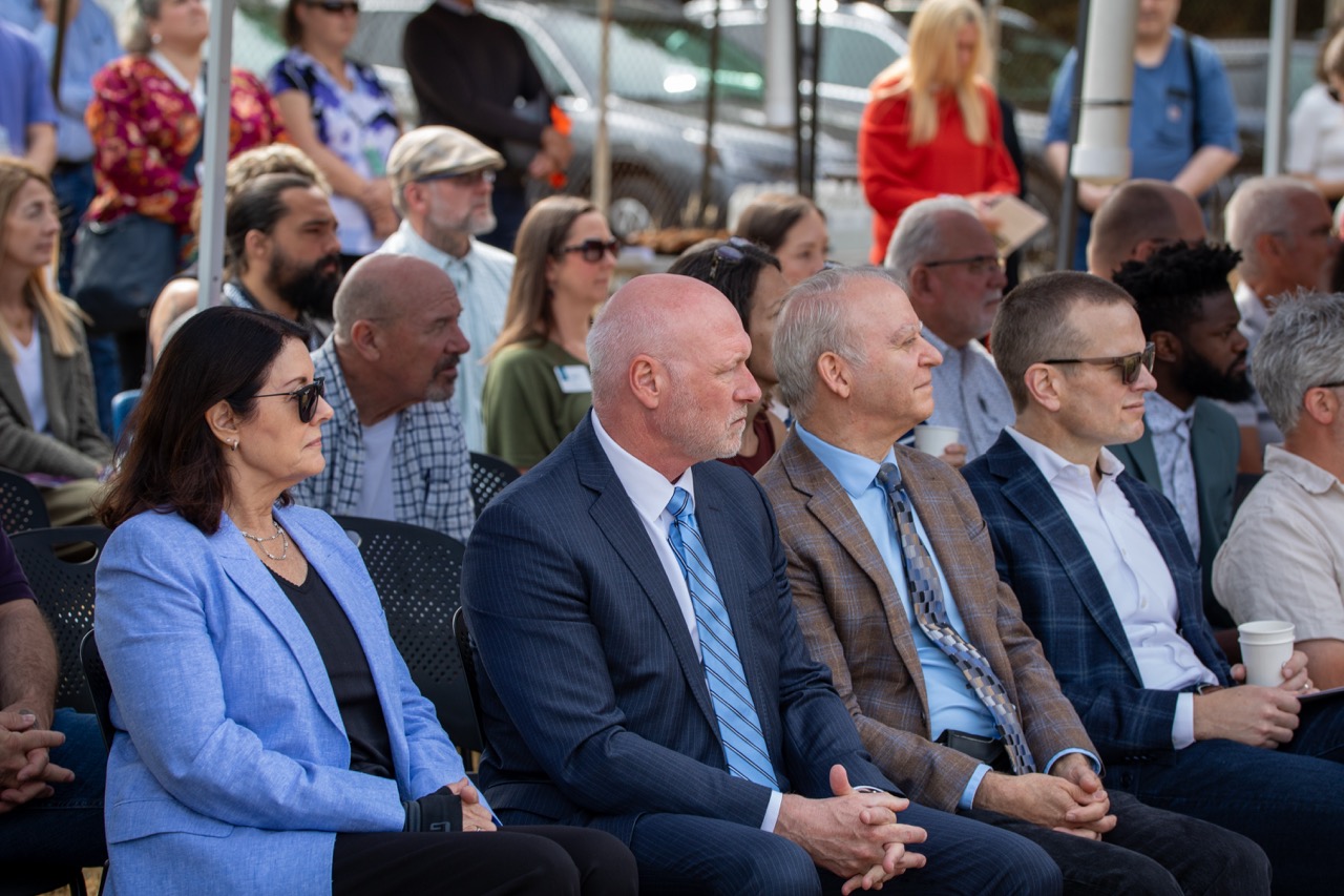 The crowd watches the speakers at the Clackamas County Recovery Campus groundbreaking on July 29, 2026. In the foreground are Clackamas County Commissioners Diana Helm, Clackamas County District Attorney John Wentworth, and Clackamas County Commissioner Paul Savas.