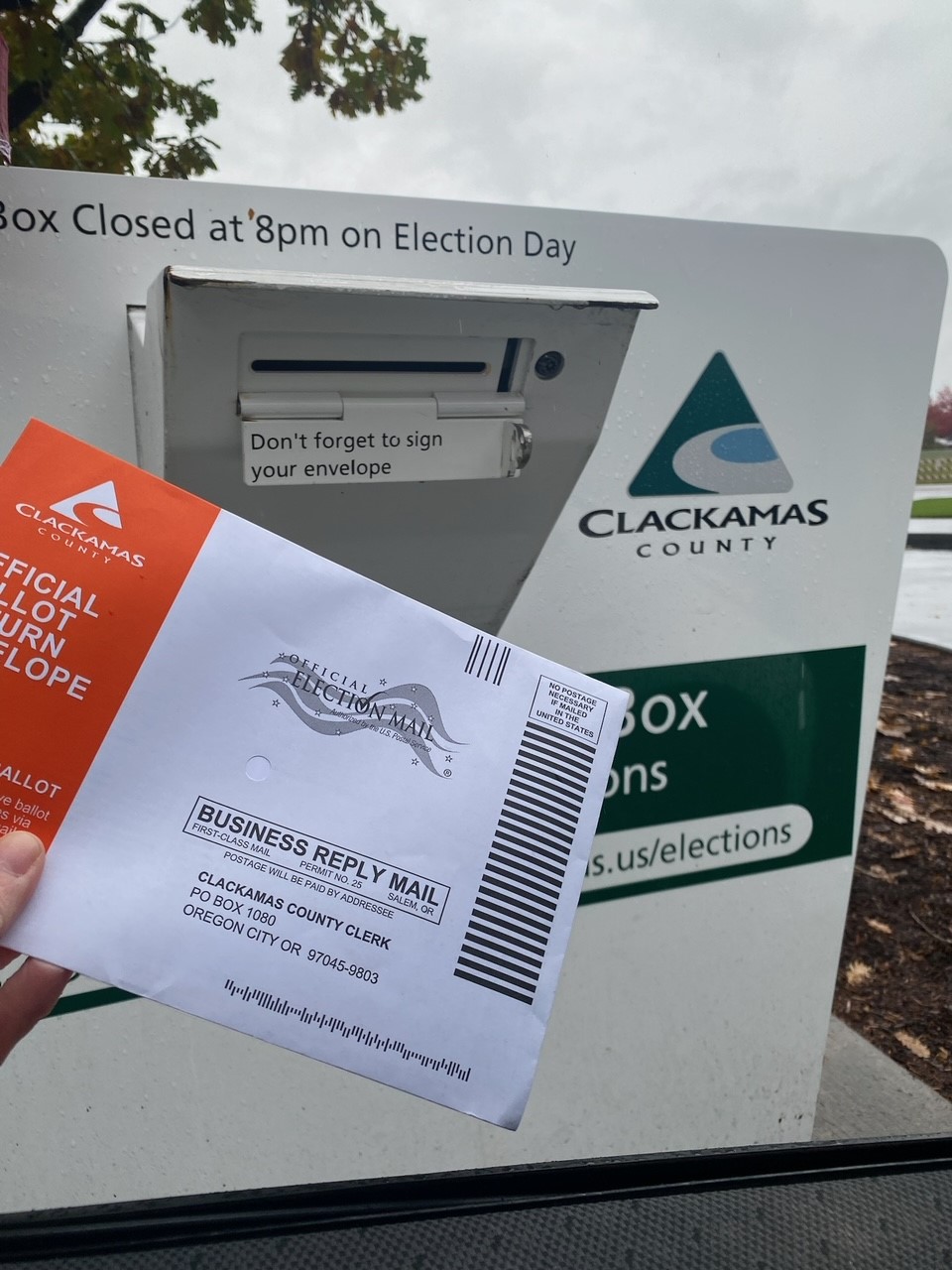 A Voter returns their ballot to an official ballot drop site