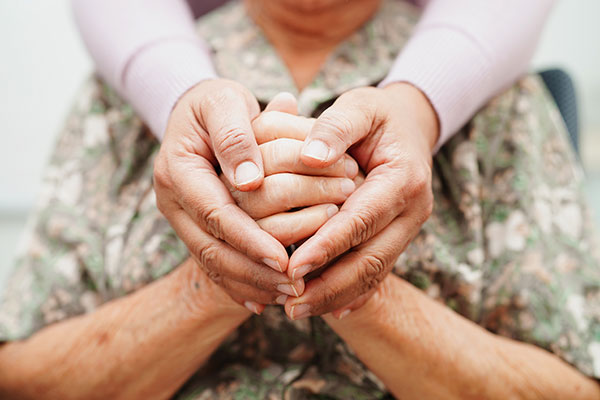 Caregiver holding hands