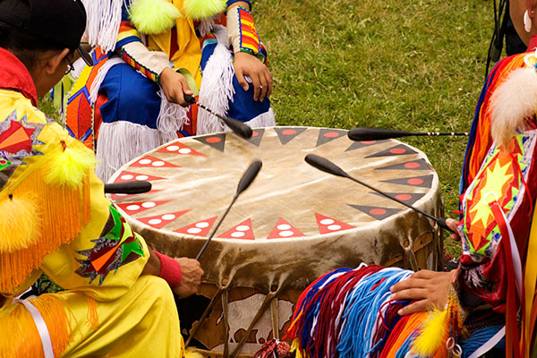 Beating Drum at Indian Pow Wow Teamwork Colorful regalia